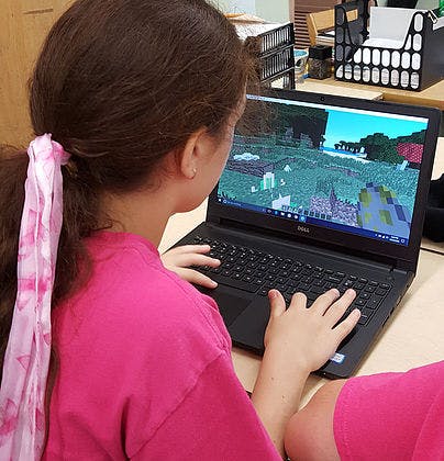 Child playing a video game on a laptop