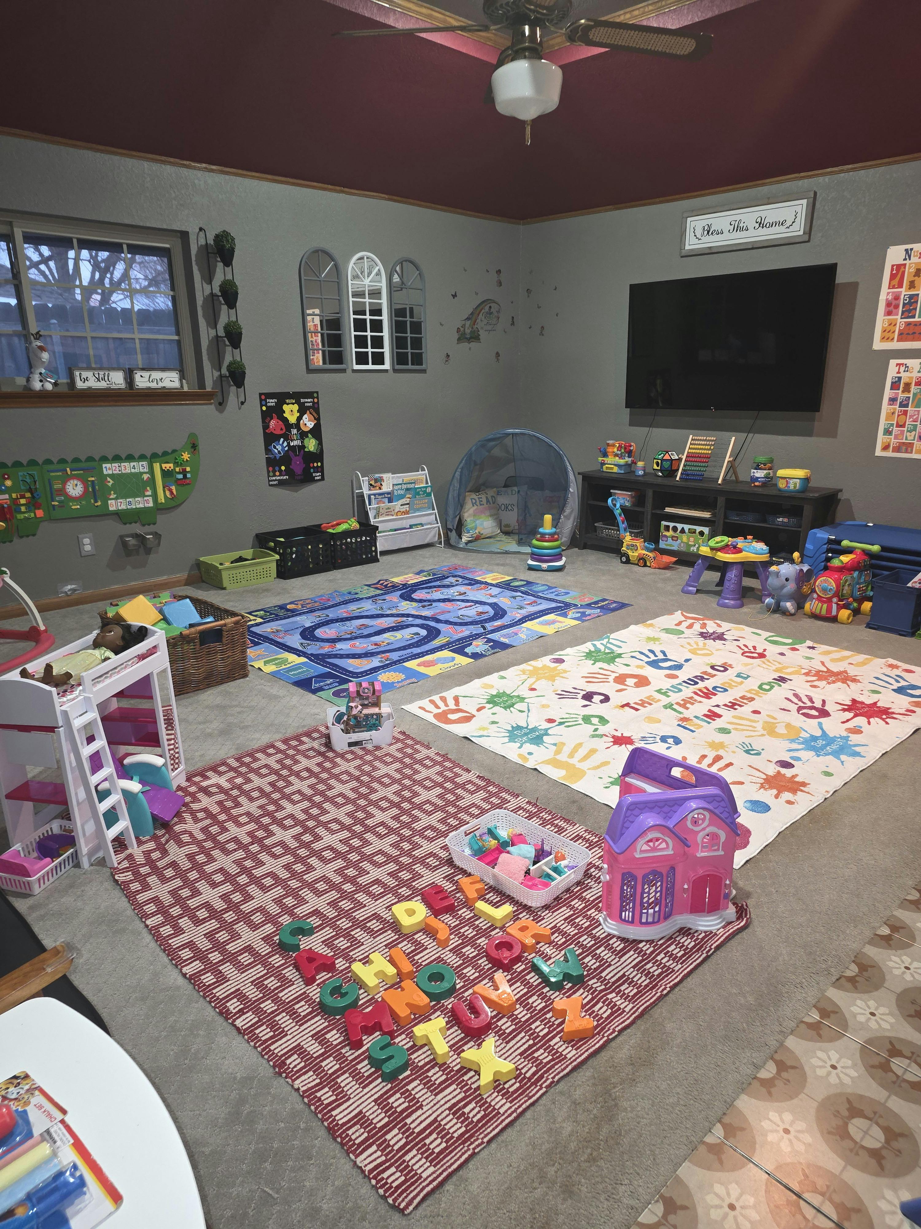 A playroom filled with toys, play mats, children's books, and other learning materials