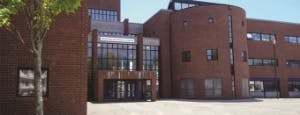 Brick building with large glass entrance and curved section