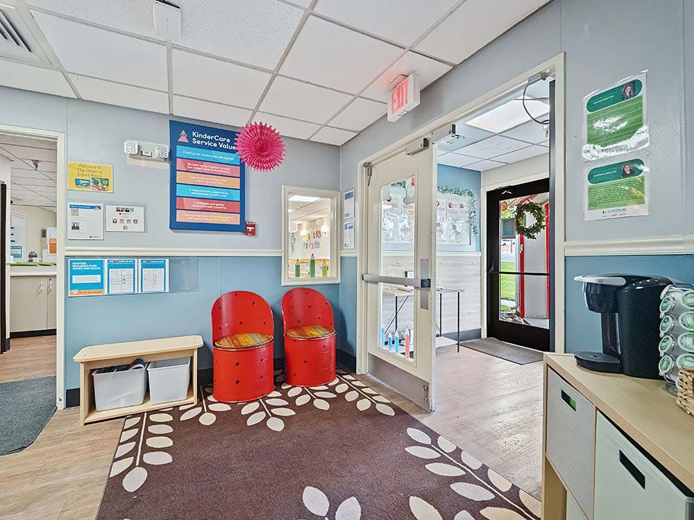 Lobby area with child-sized seating and wall-mounted information panels