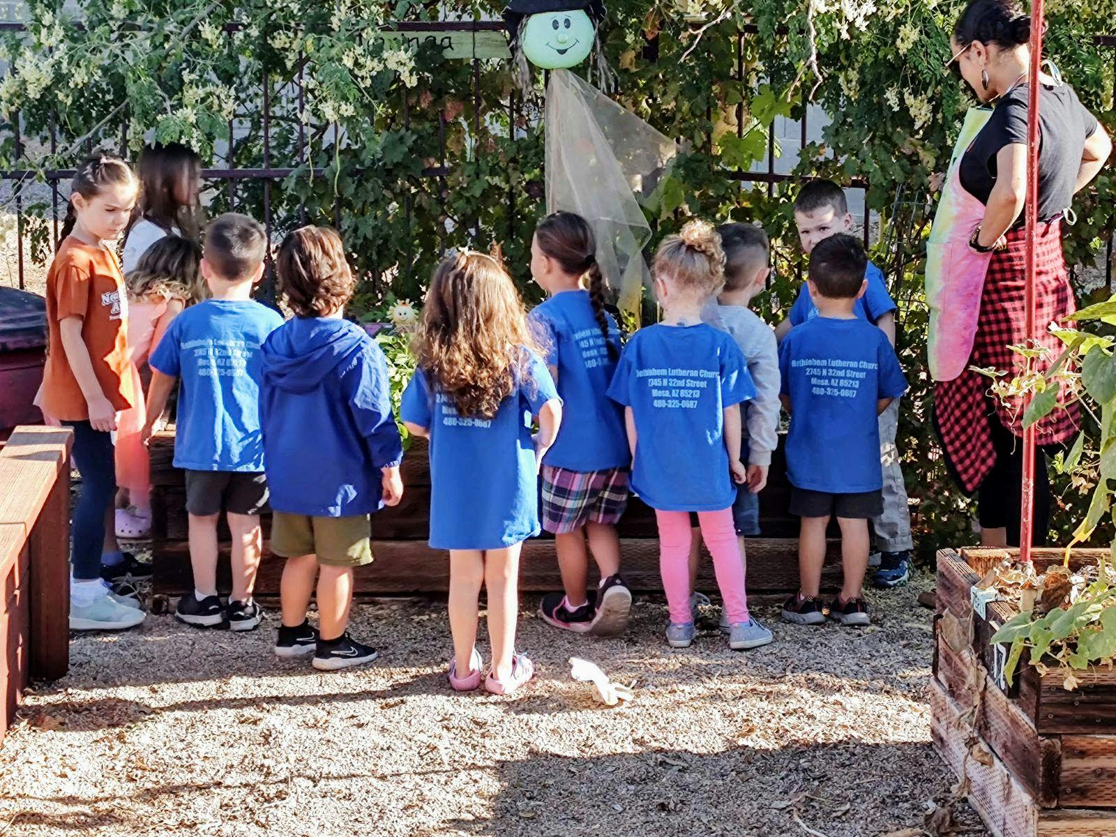 Group of children and an adult standing outdoors