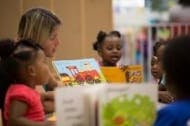 Adult reading to children in a classroom