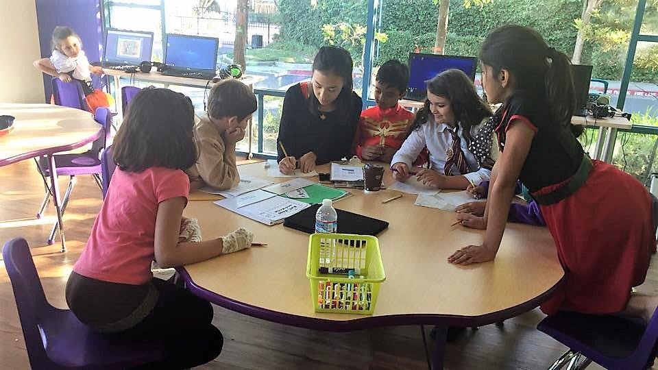 Adult and children gathered around a table