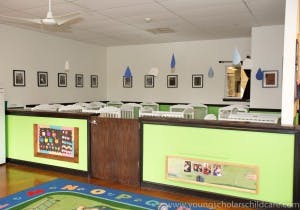 classroom with tables and chairs, decorated walls