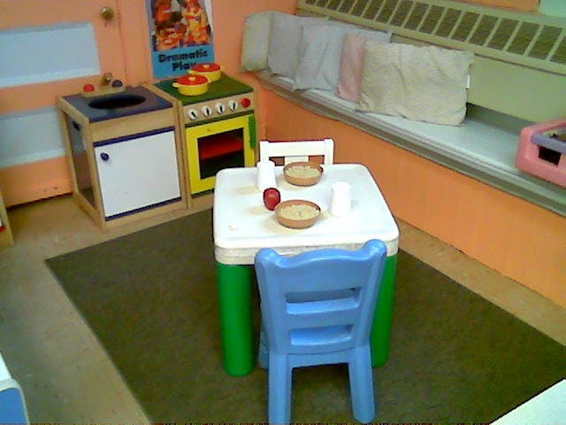 Play kitchen set with a small table and chairs