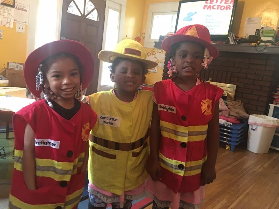Three children in firefighter costumes