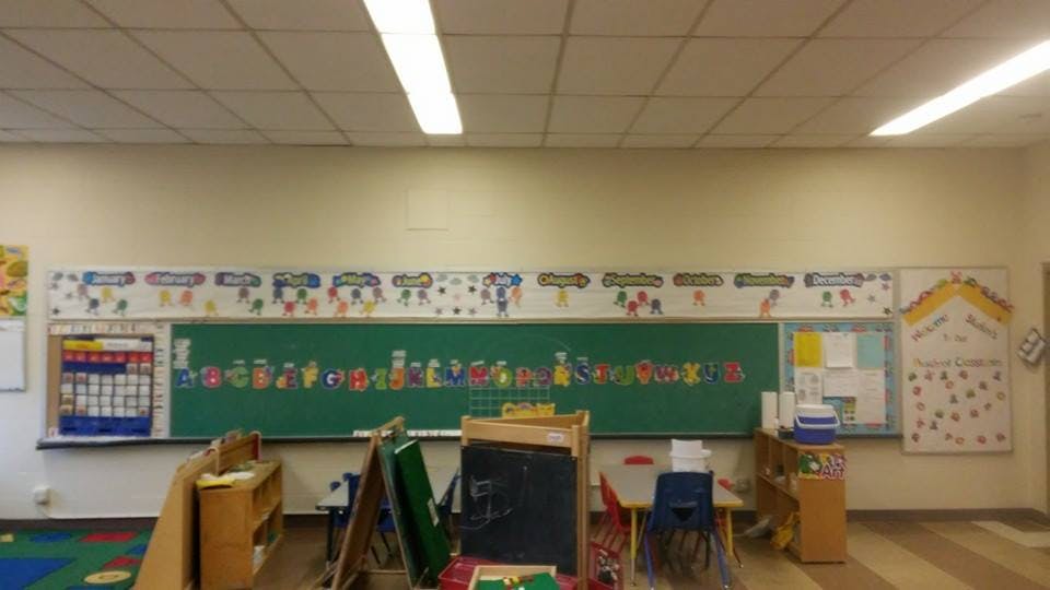 Classroom with a green chalkboard and colorful decorations