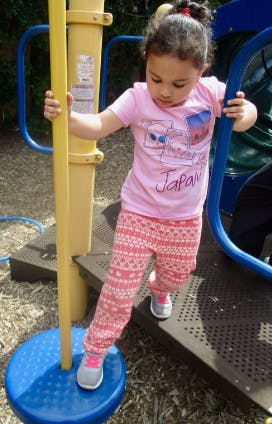 Child on a playground climbing on equipment