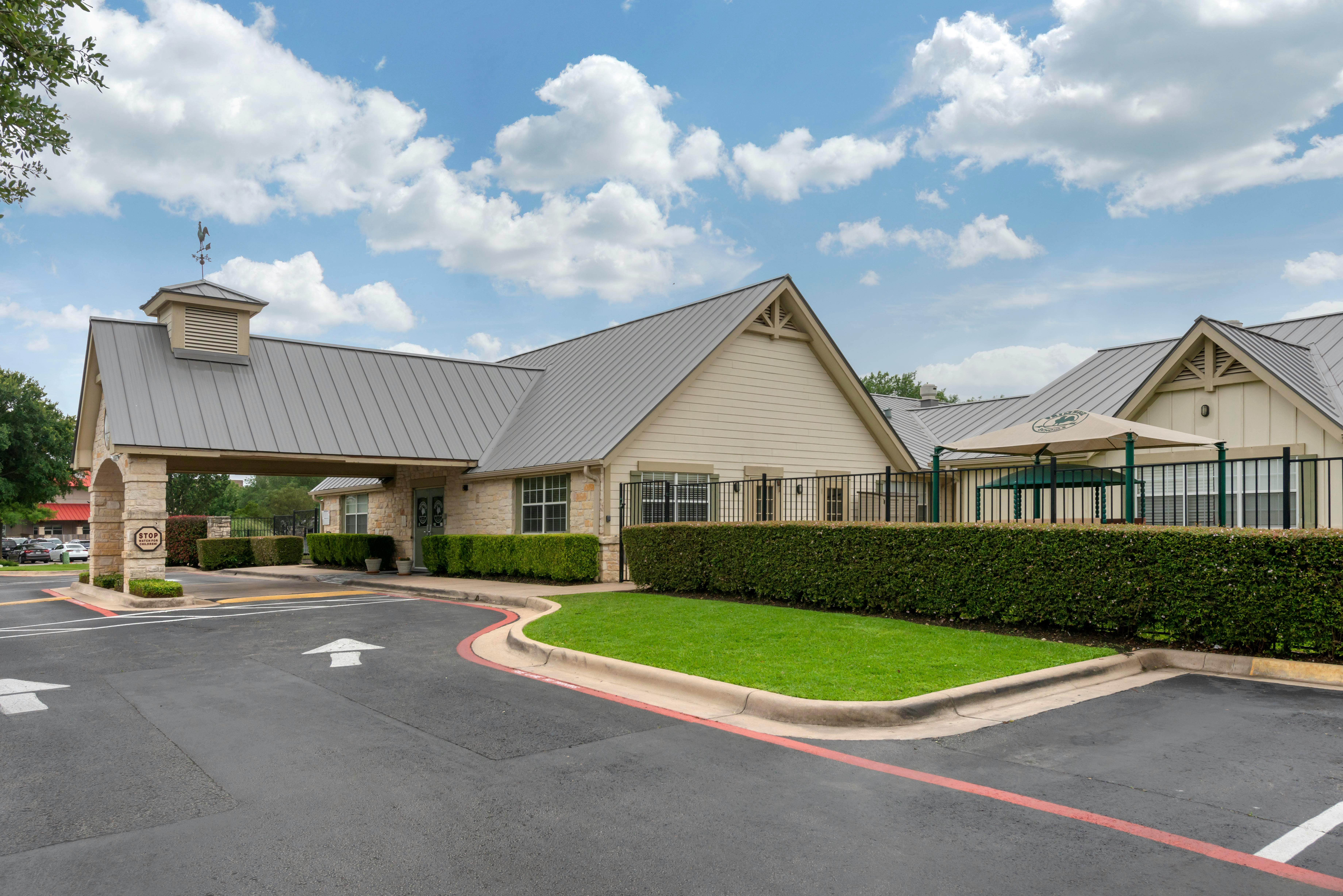Exterior view of a building with a gray roof and light-colored siding