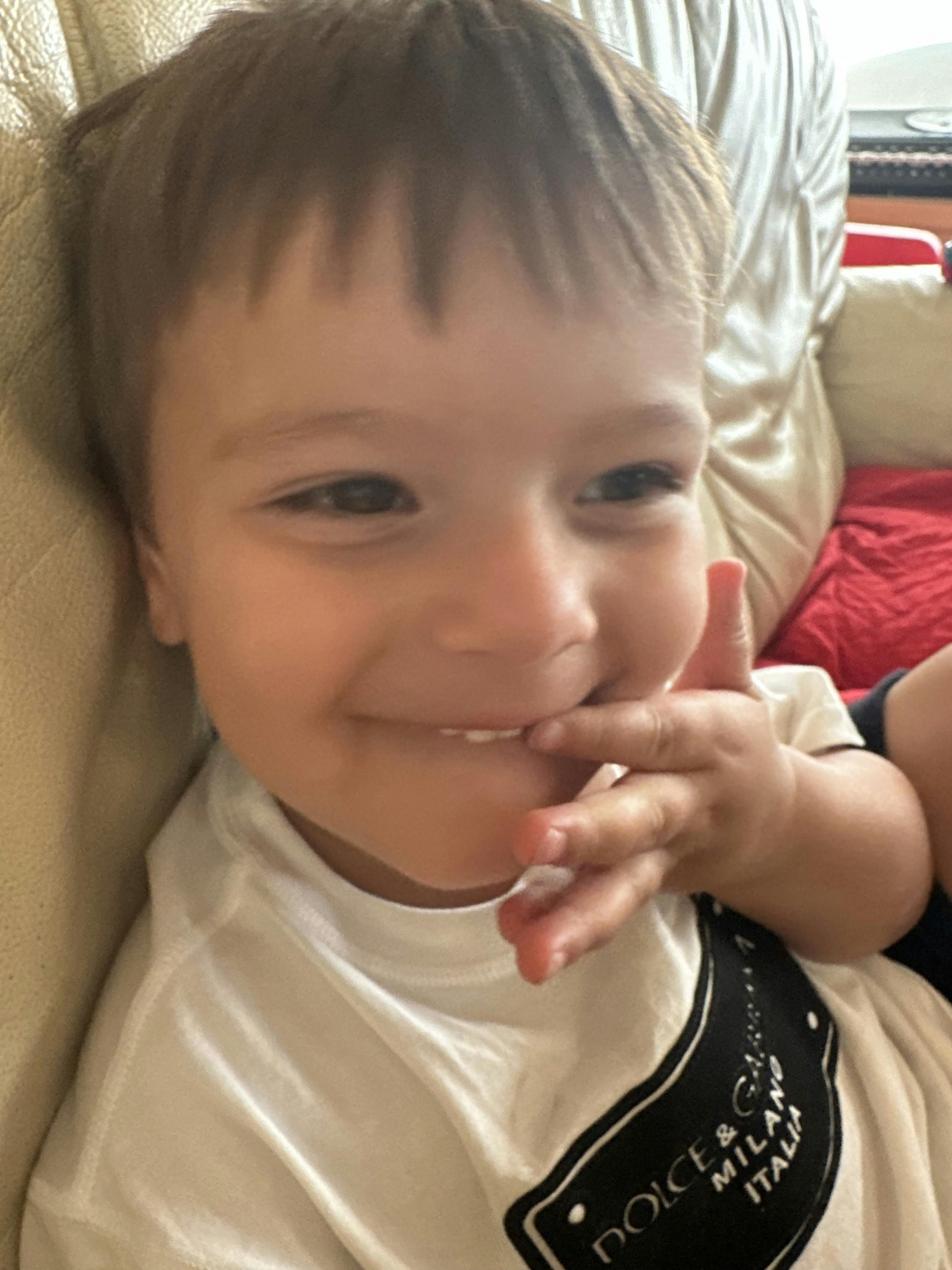 Child with fingers near mouth