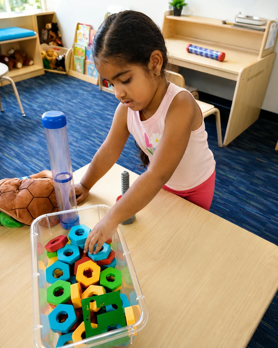 Child playing with colorful building blocks at a table
