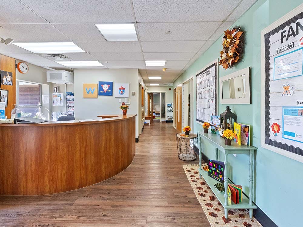 Long hallway in an office or school building with a reception desk
