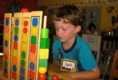 Child playing with colorful stacking blocks