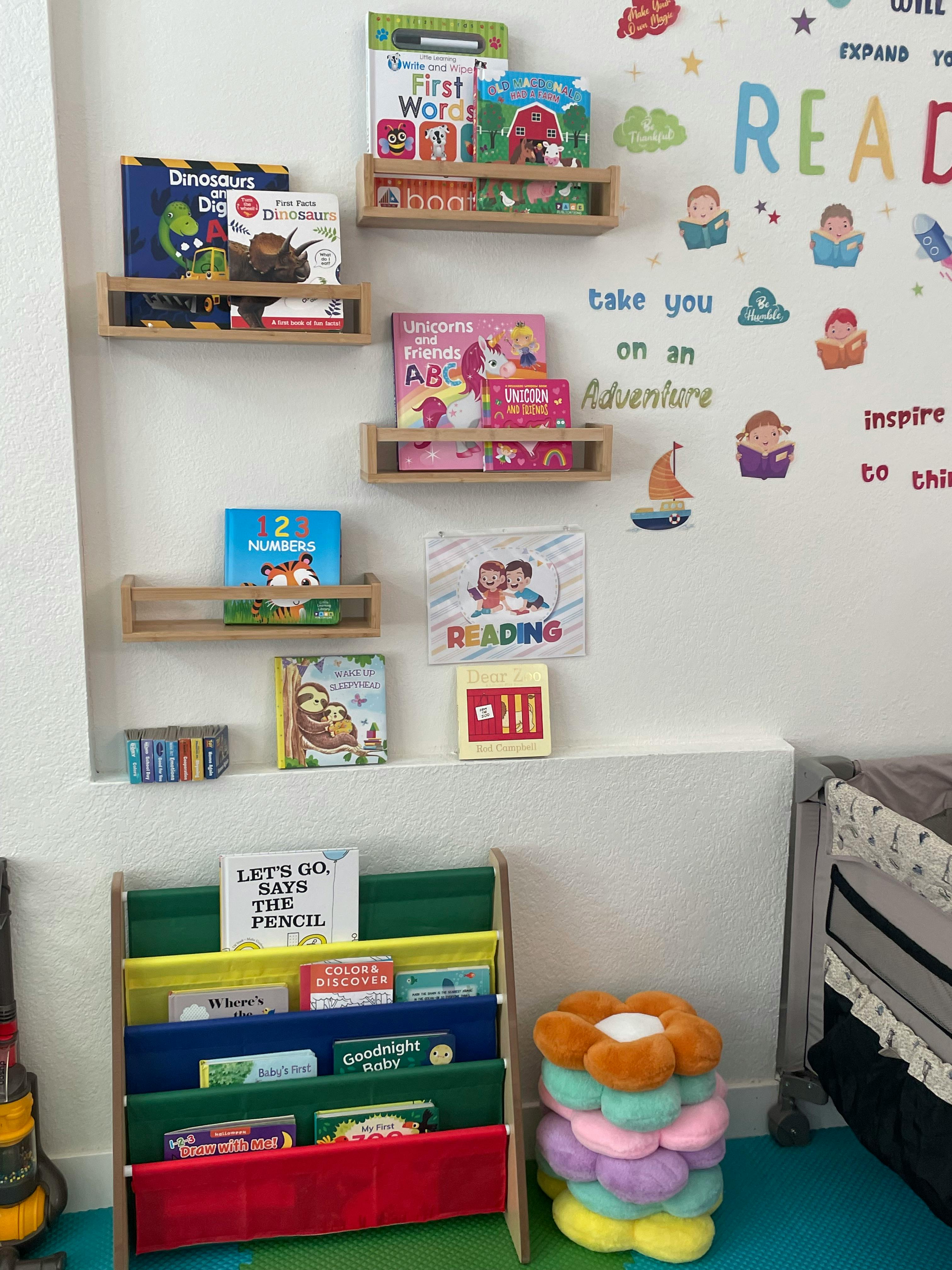Children's books on wall shelves and a floor book display