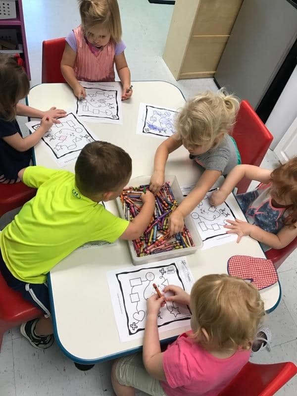 Children coloring at a table