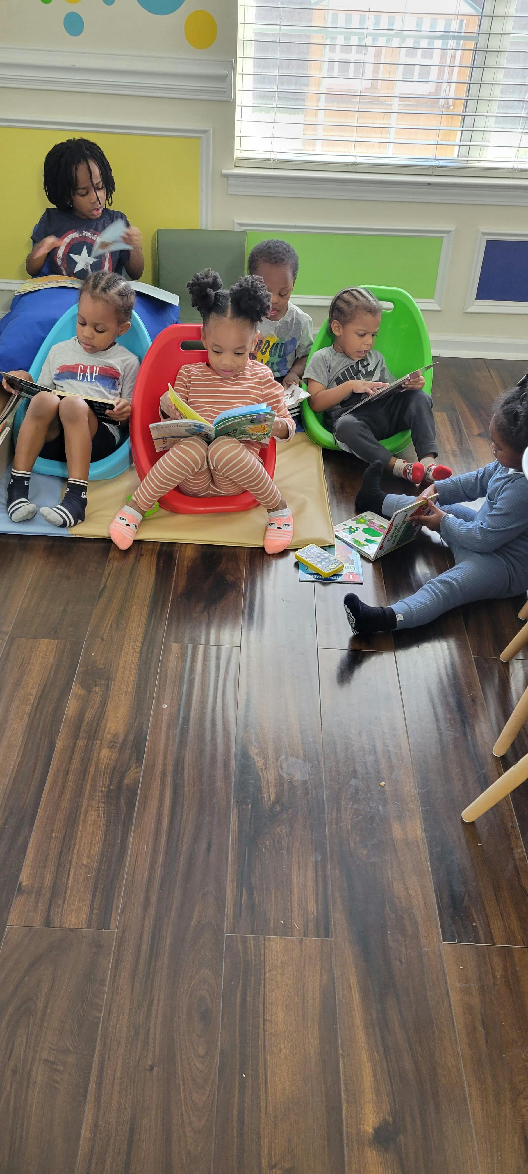 Children sitting and reading books in a classroom