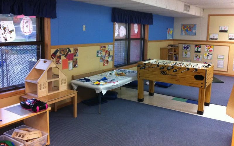 Dollhouse and foosball table in a classroom