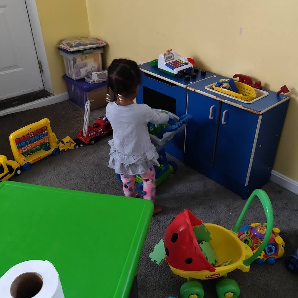 Child playing with toys in a room