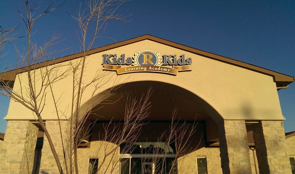 Building with "Kids R Kids Learning Academy" sign