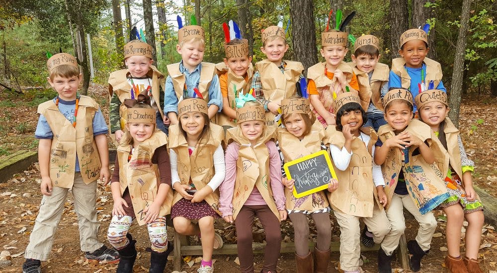 Group of children in costumes posing outdoors