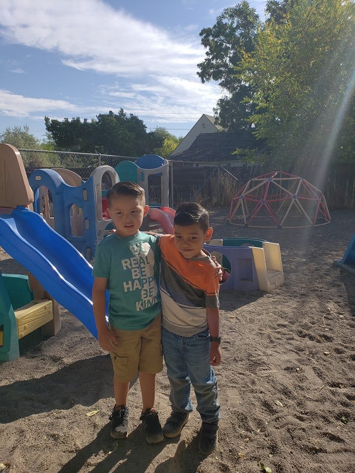 Two children standing together on a playground