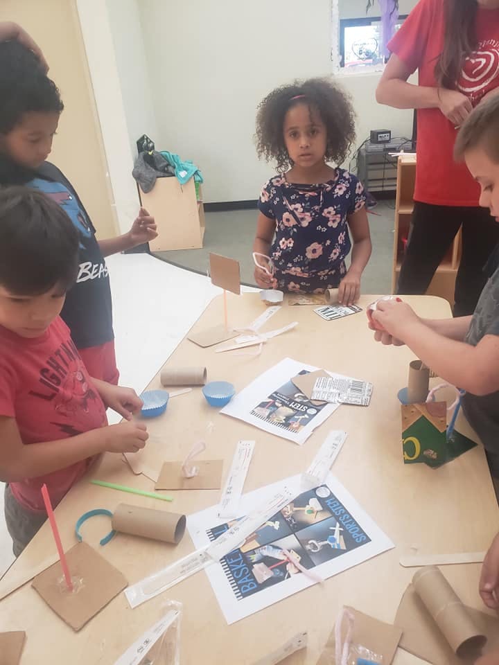 Children making crafts at a table