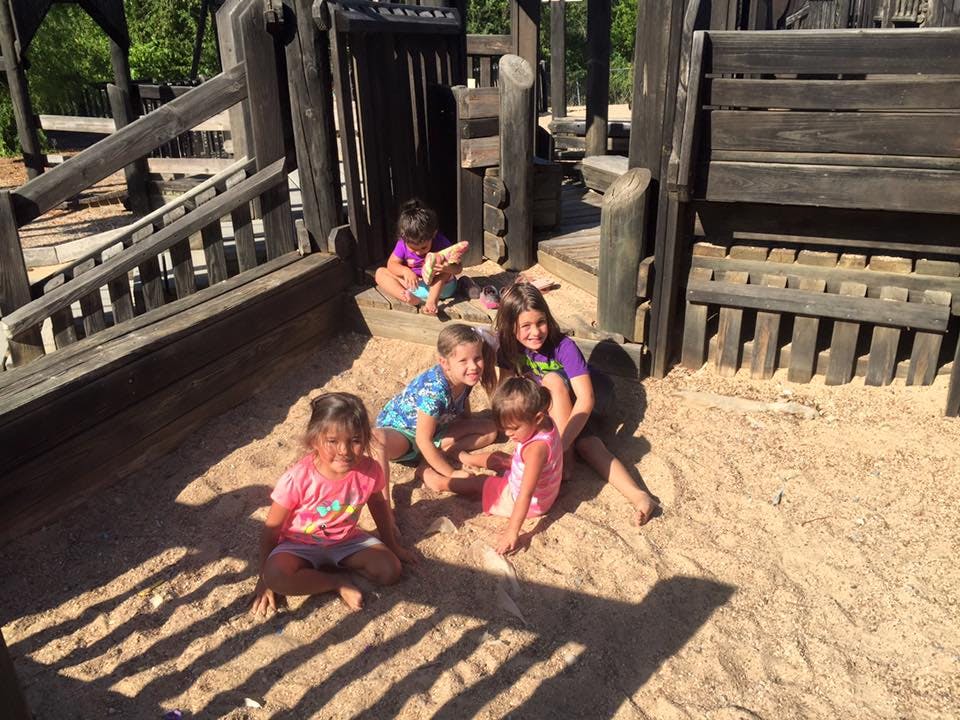 Children playing in a sandbox at a playground