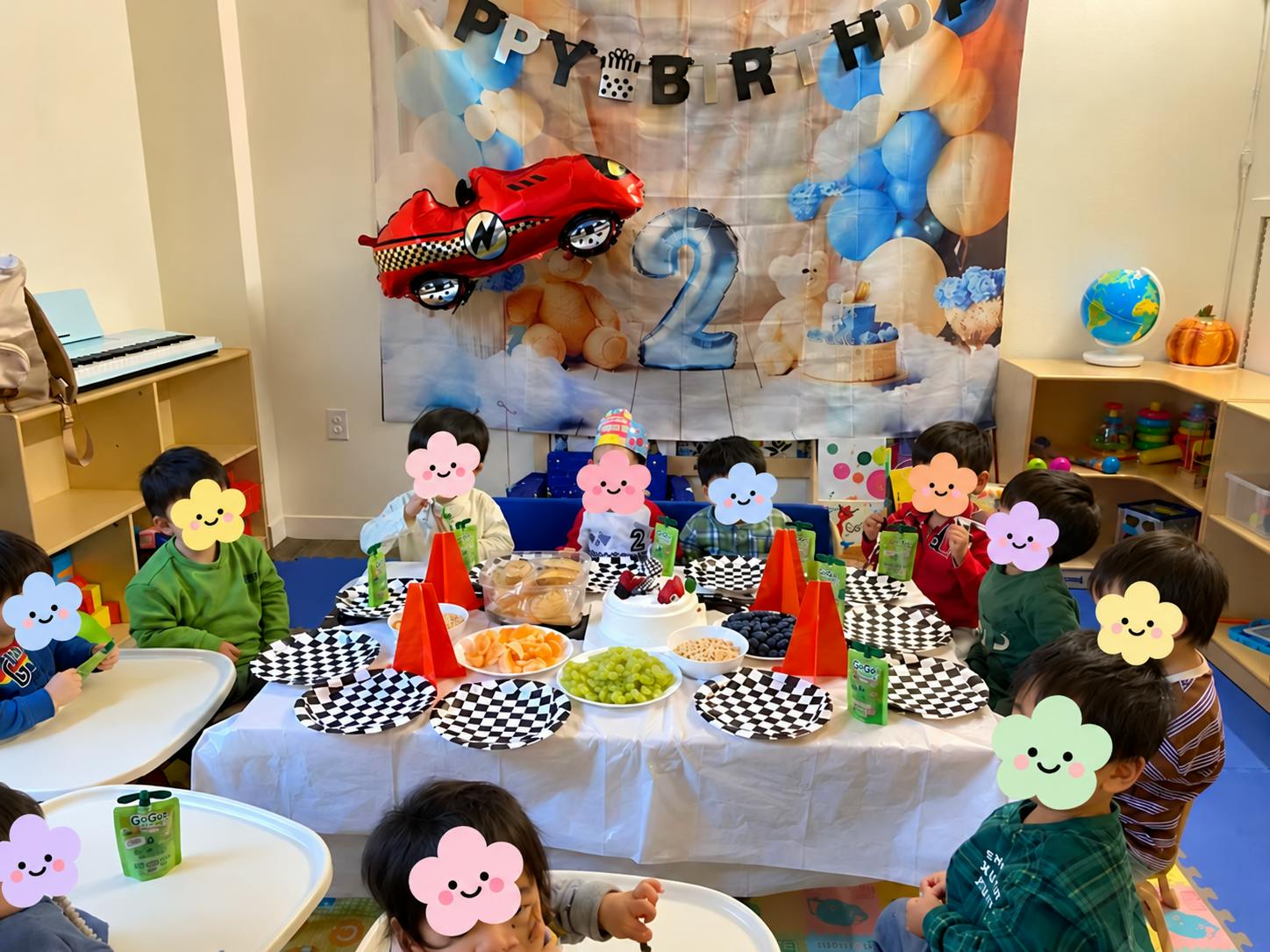 Group of children gathered around a birthday party table