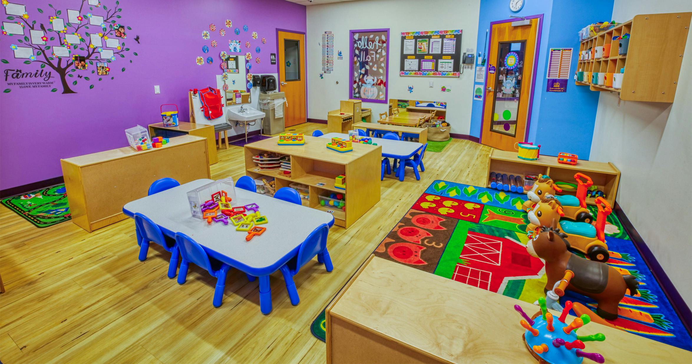 Colorful playroom with small tables, chairs, and toys for children