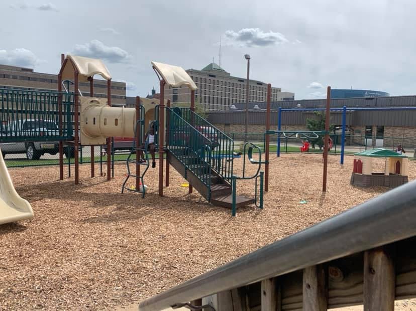 Empty playground with slides, swings, and climbing structures