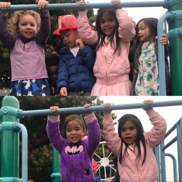 Children hanging from monkey bars on a playground