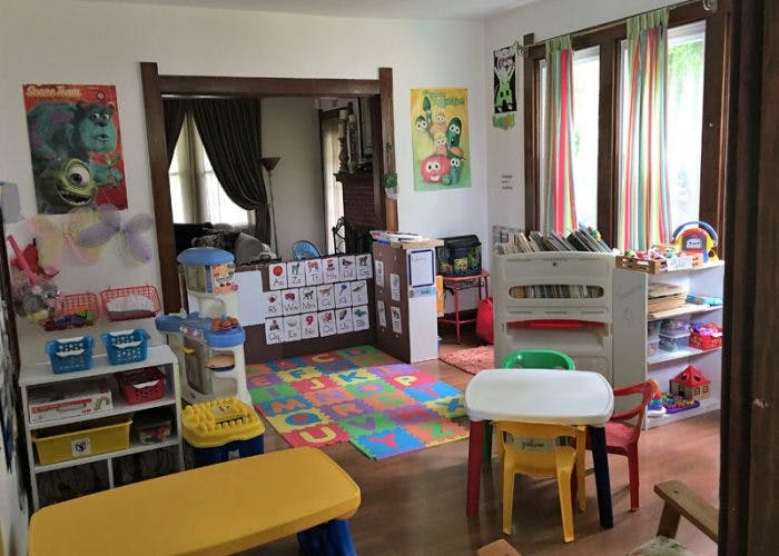 Playroom with colorful floor mat and child-sized furniture