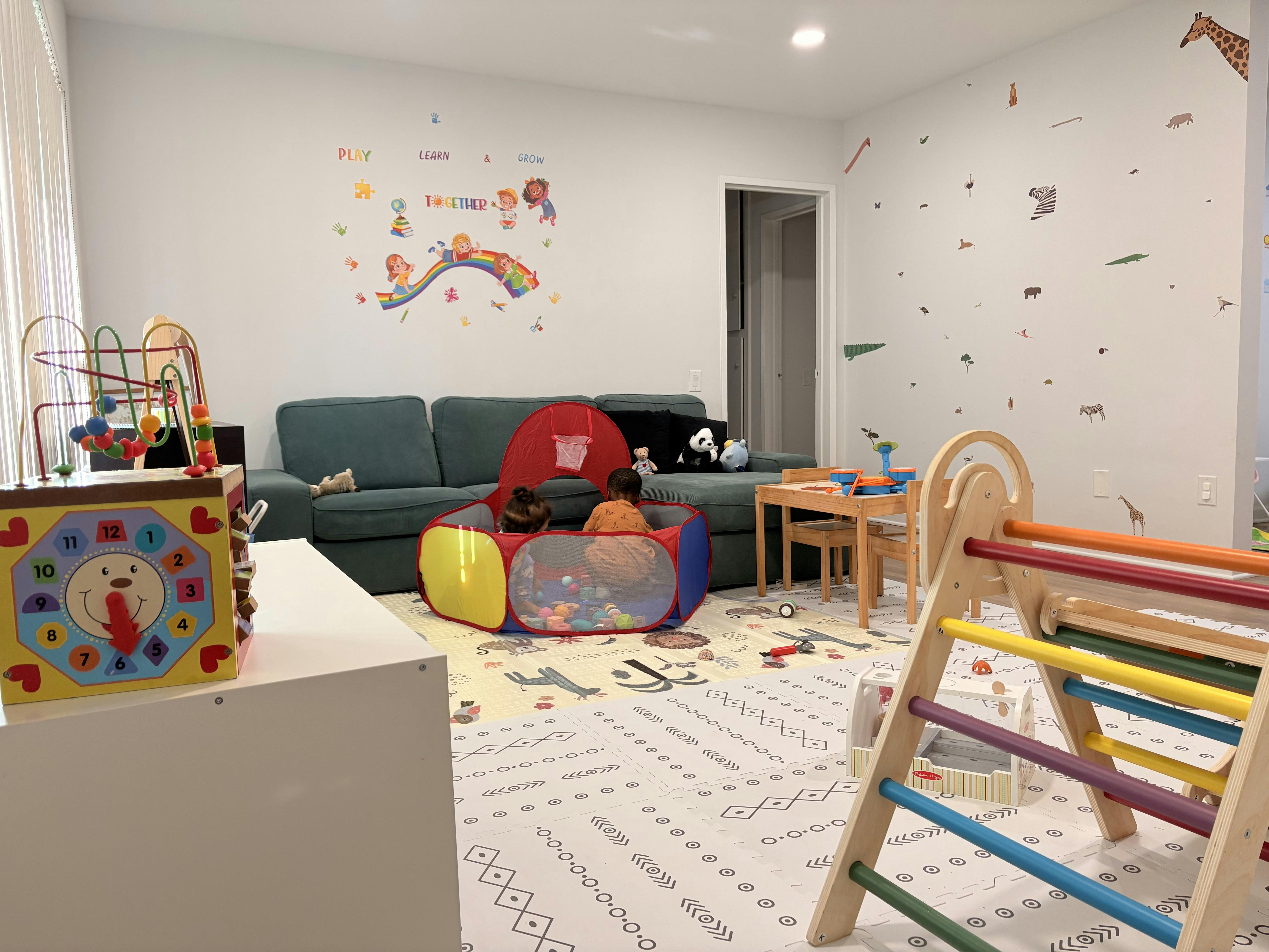 Children playing in a pop-up tent in a playroom
