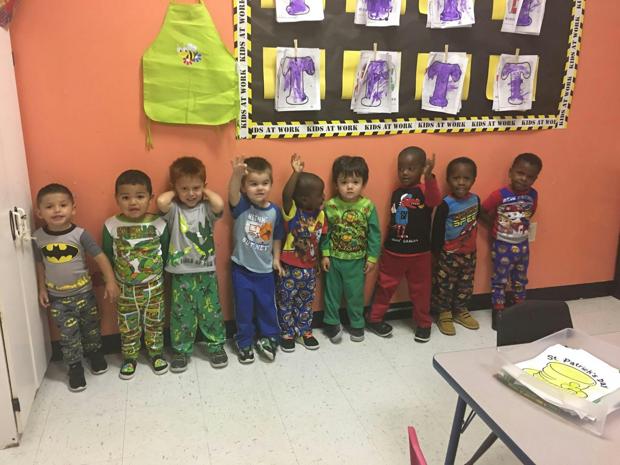 Group of children standing in a line in a classroom