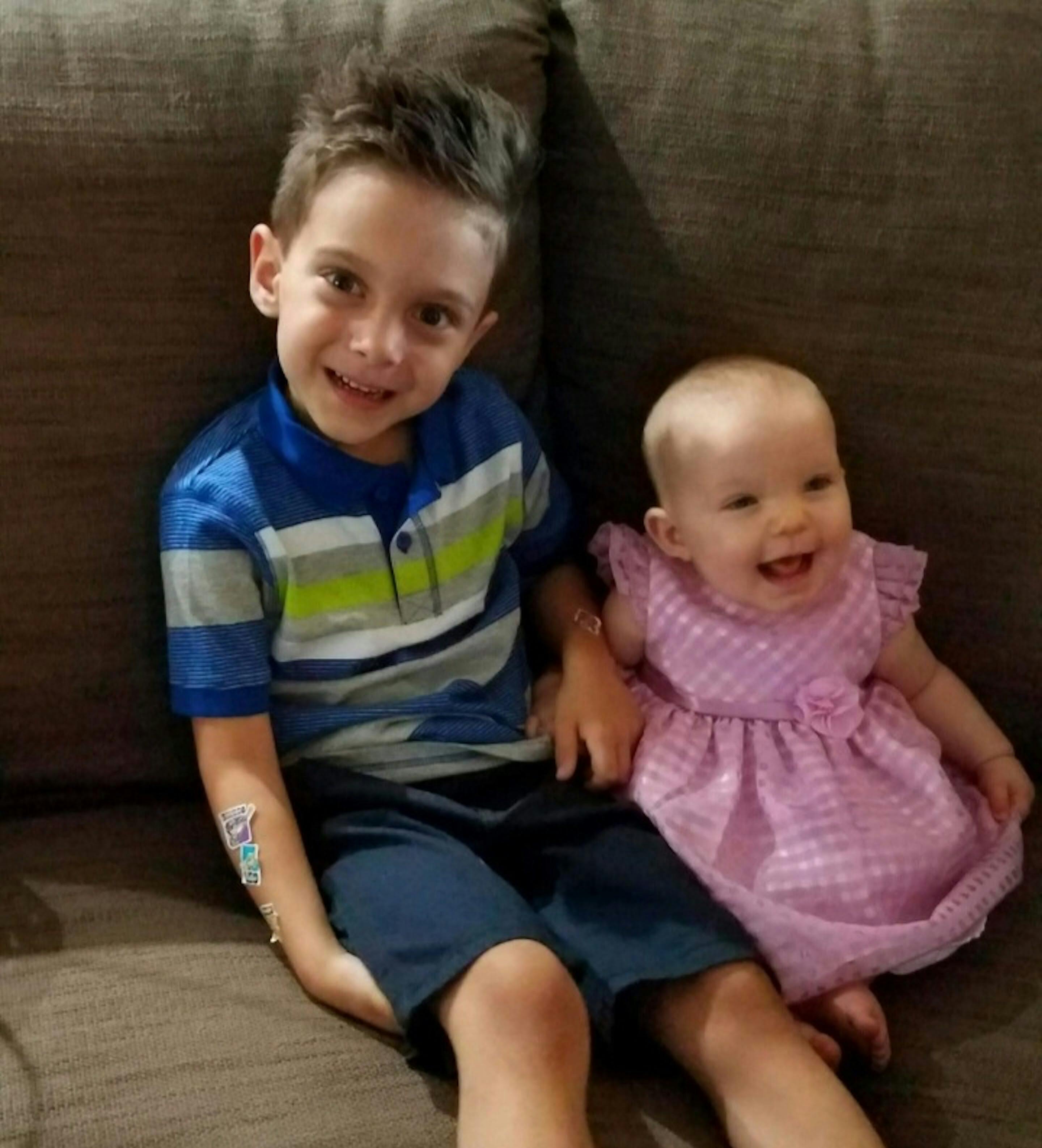 Child and baby sitting on a couch