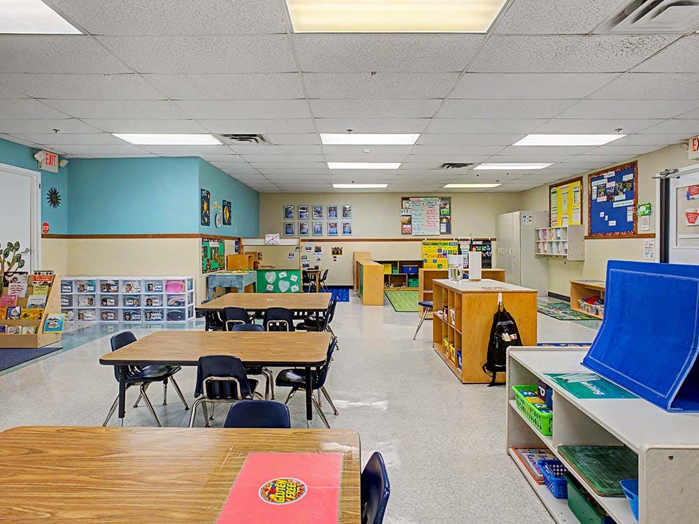 Empty classroom with small tables and chairs