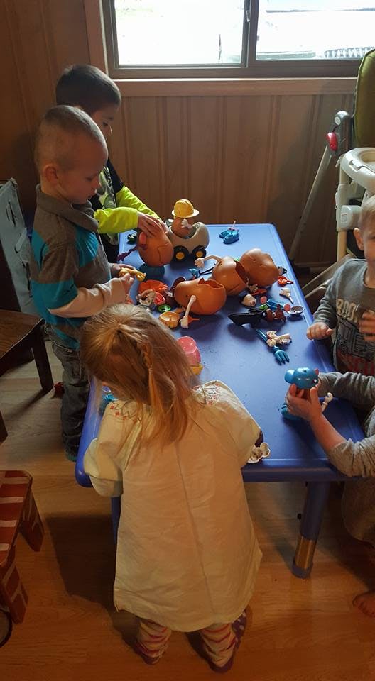 Children playing with toys at a blue table