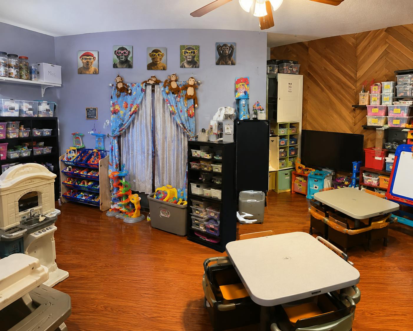 Playroom interior with children tables, shelves of toys, and monkey decor