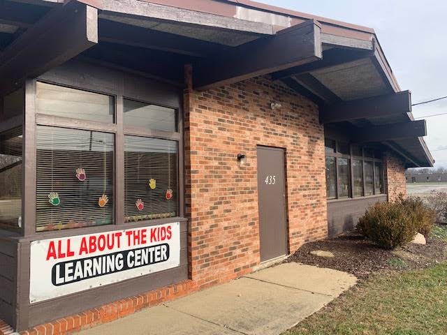 Brick building with a sign that reads "All About The Kids Learning Center"