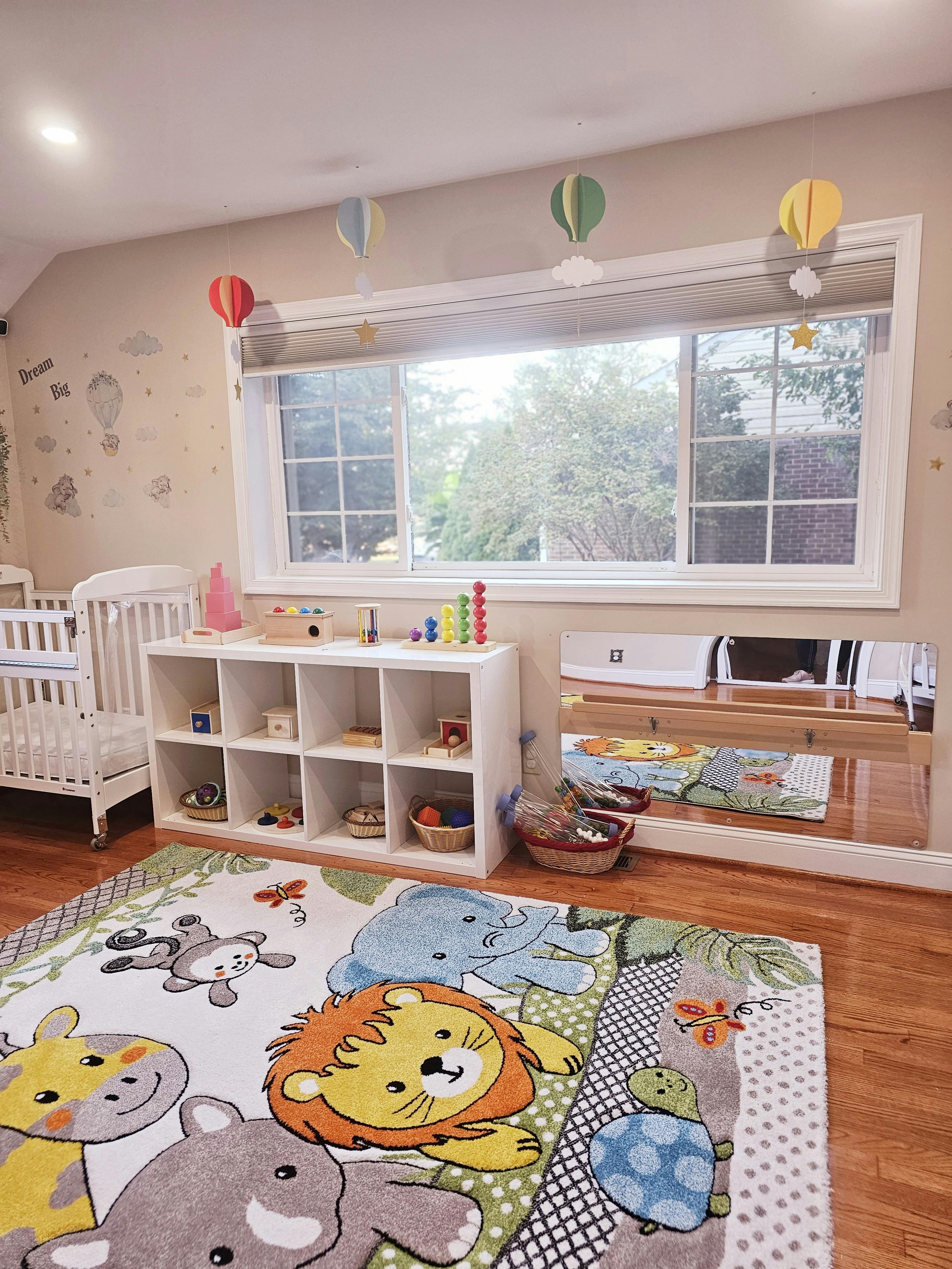 Nursery room with a crib, toy shelf, and animal-themed rug