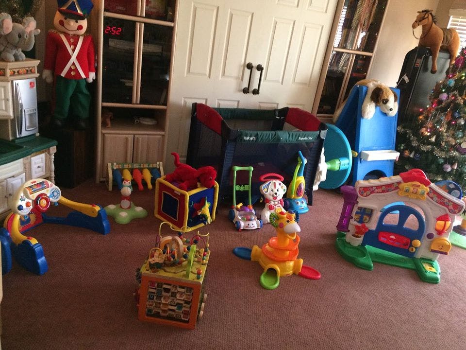 Room with various colorful children's toys on the floor