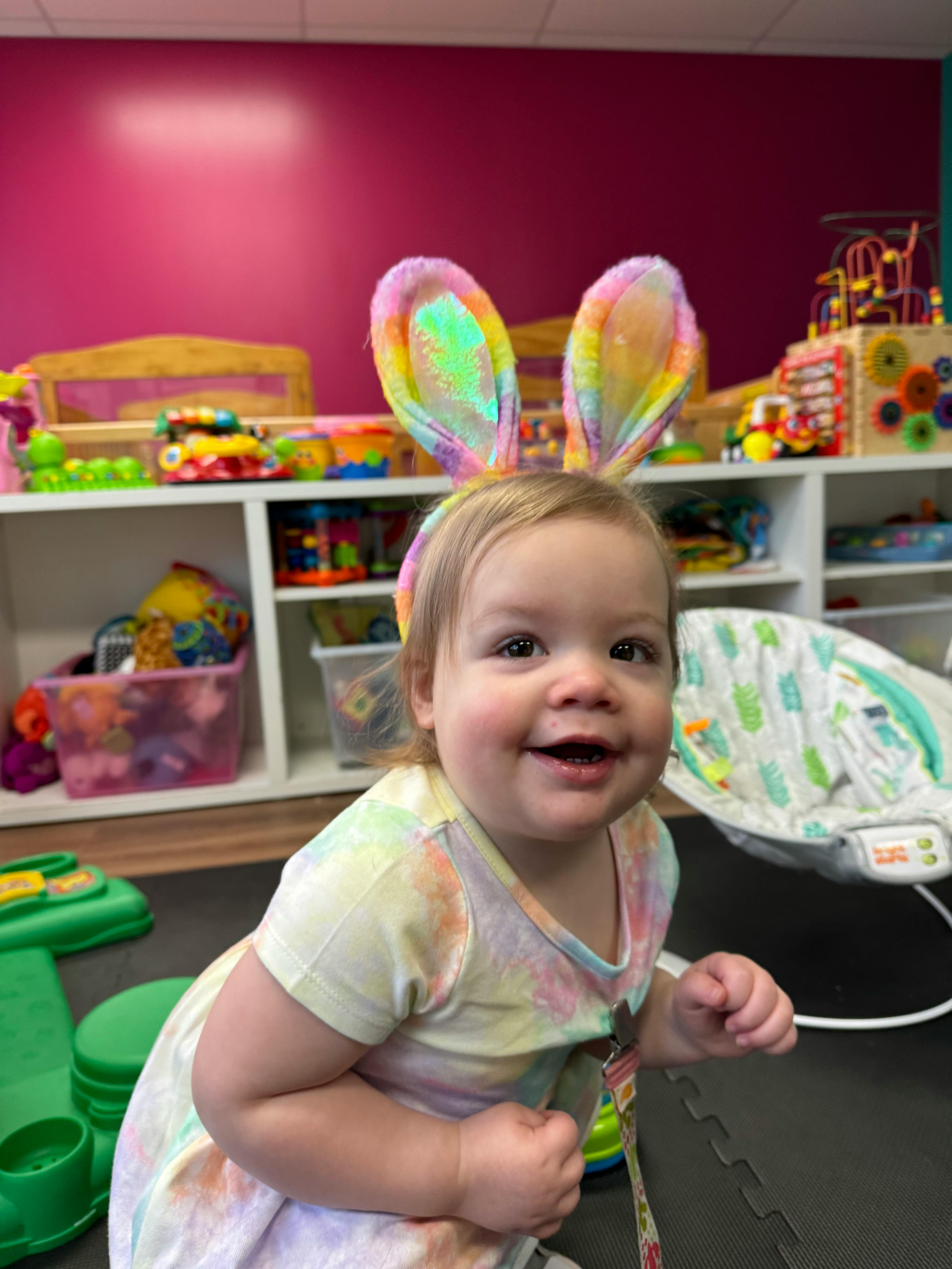 Child wearing colorful bunny ears