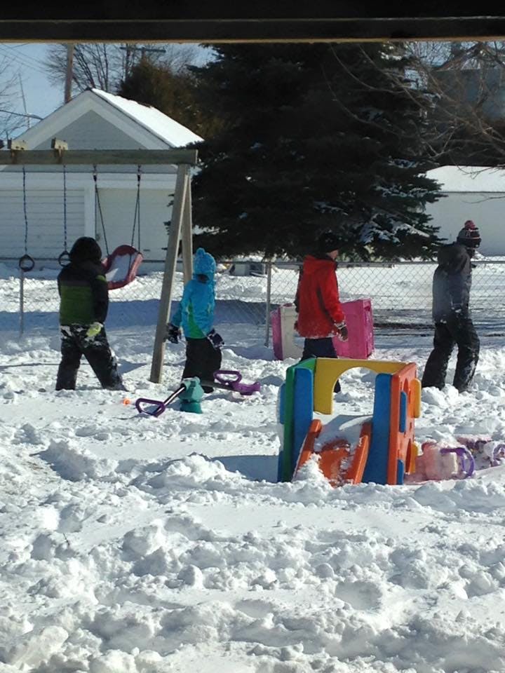 Children playing in a snowy playground