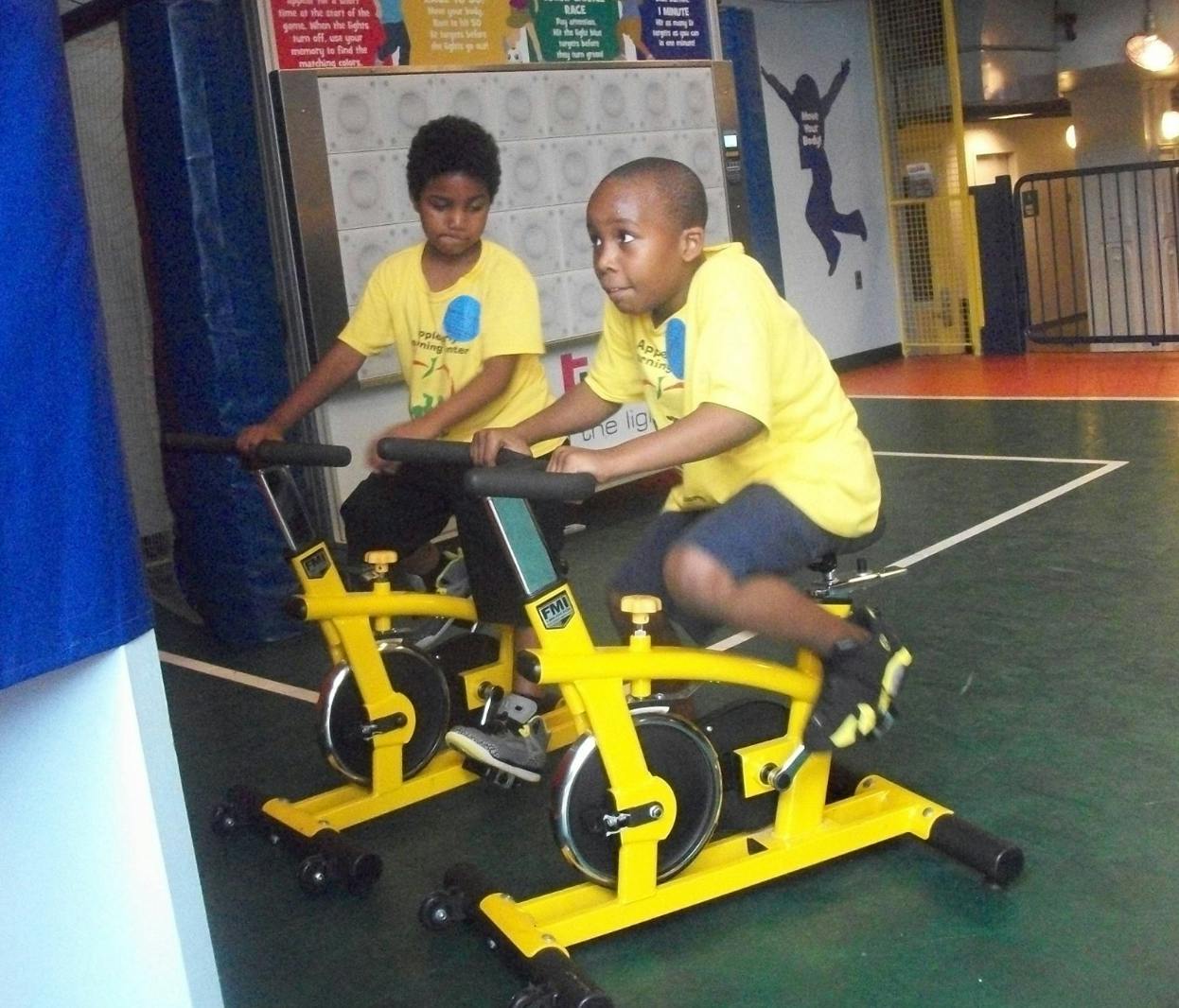 Two children on stationary bikes