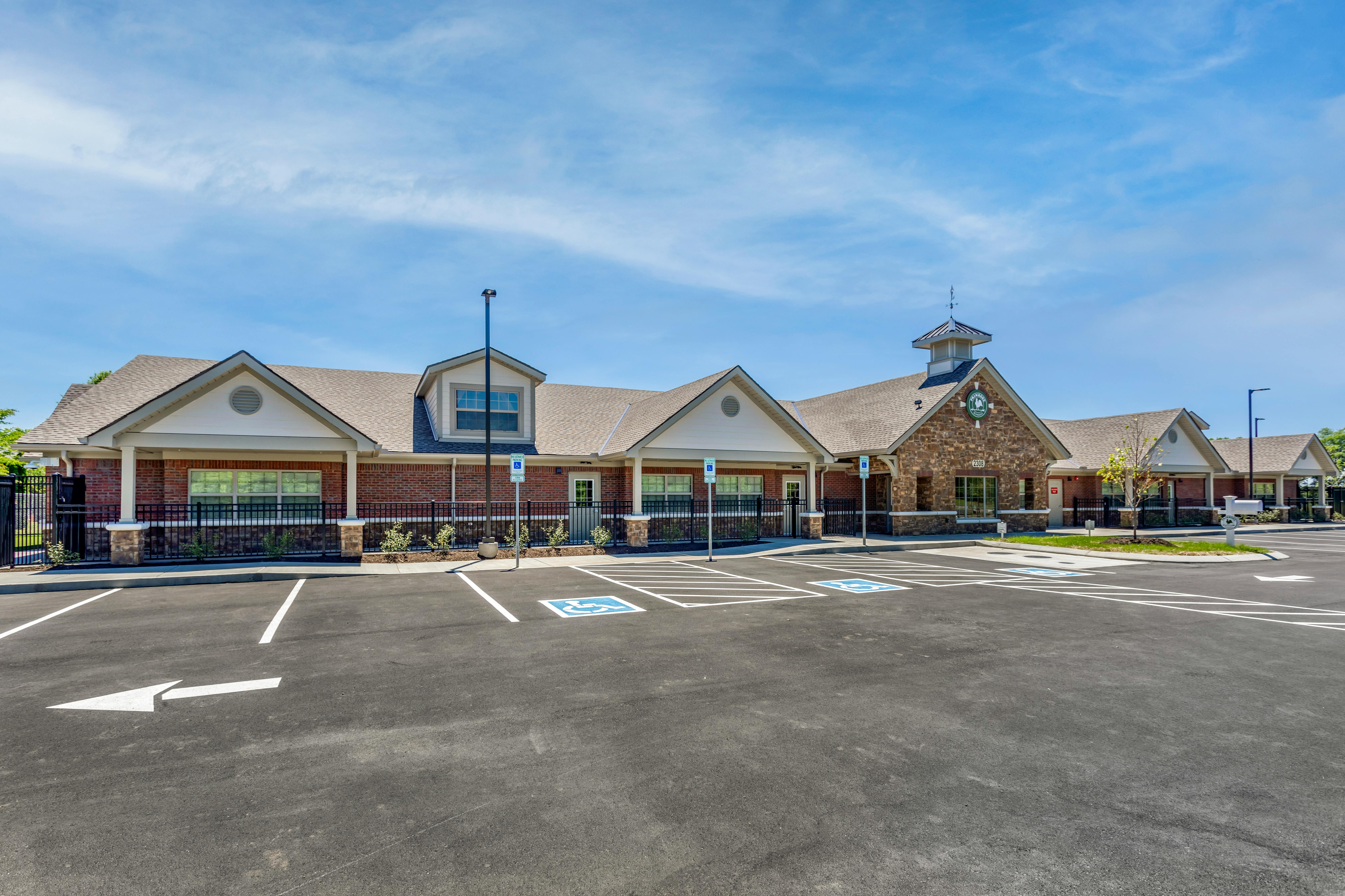 Brick building with a parking lot in front