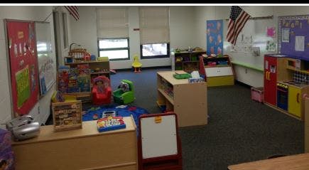 Classroom with small chairs, tables, and toys