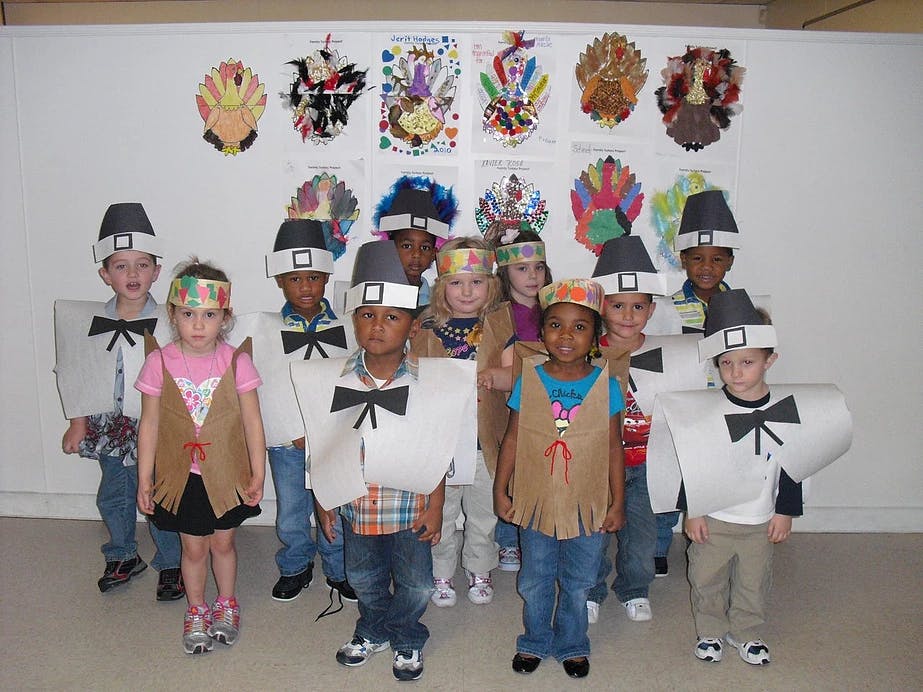 Children in pilgrim and Native American costumes