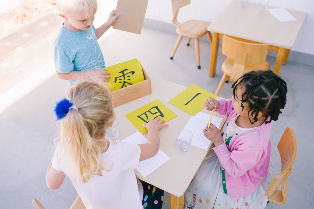 Children learning with flashcards at a table