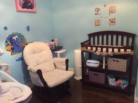 Nursery room with a glider chair and a changing table