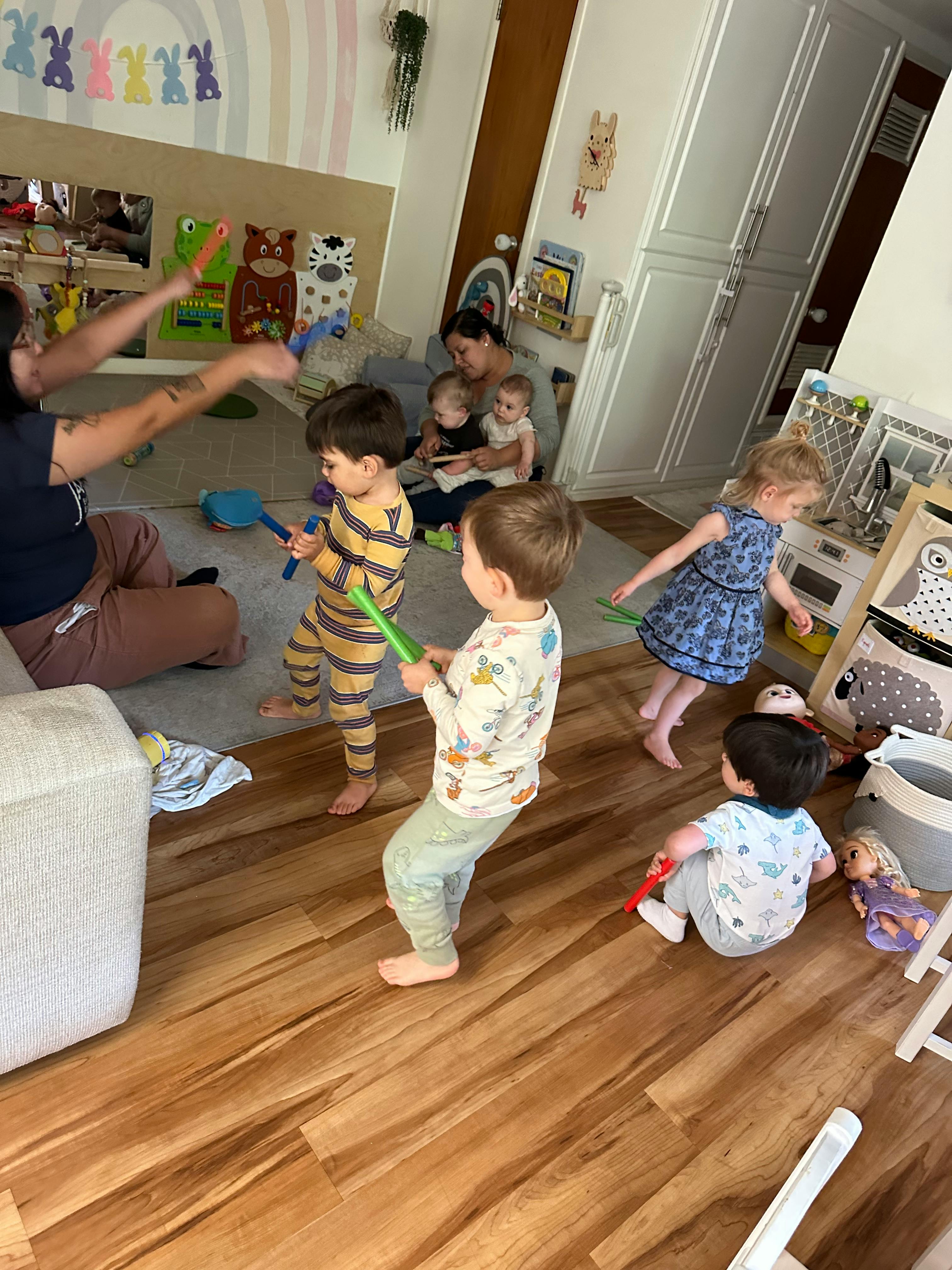 Adults and children playing with toys in a room